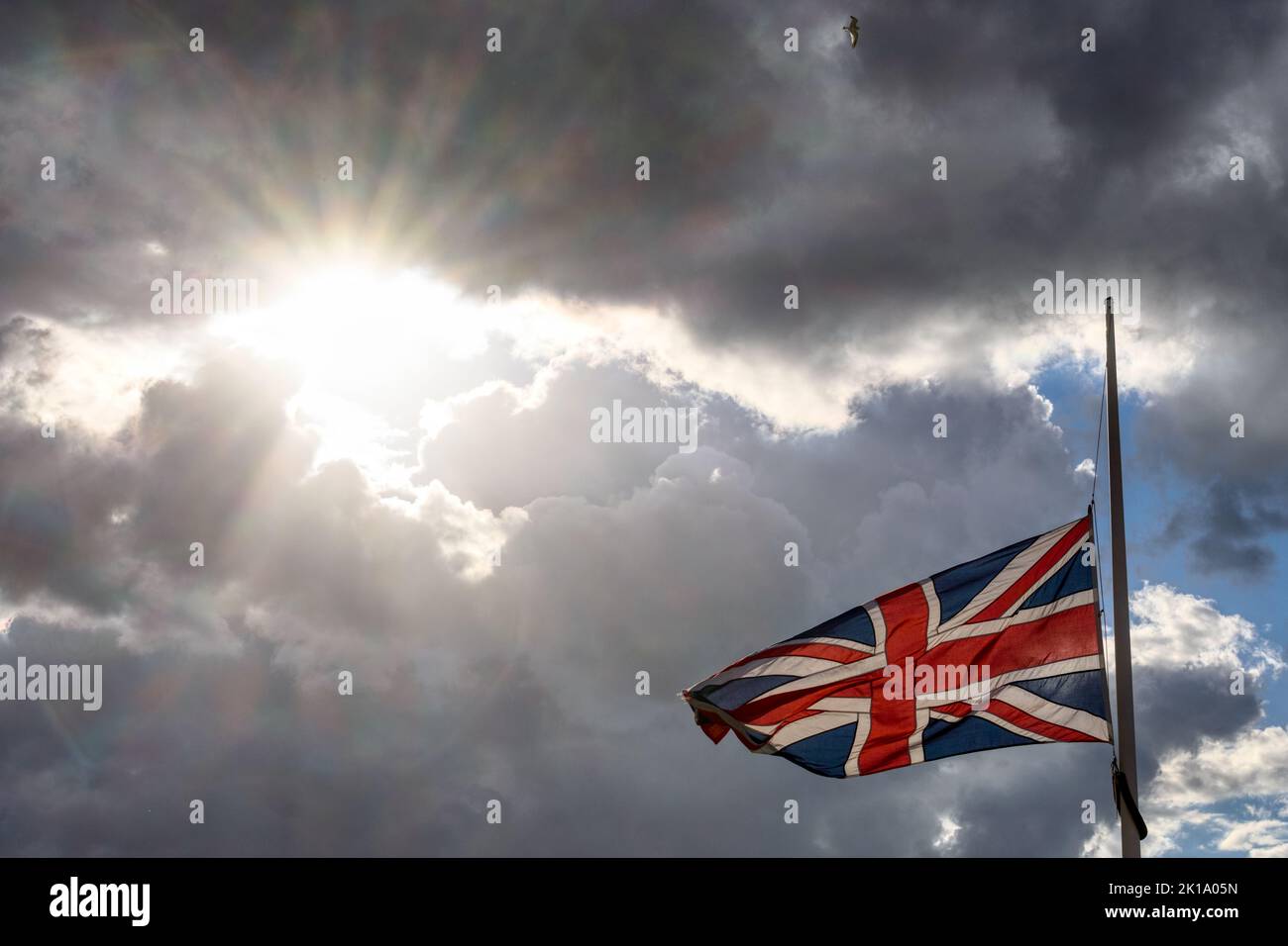 A flag flies at half-mast on Herne Bay Pier during the period of national mourning after Her Majesty Queen Elizabeth II's death in September 2022. Stock Photo