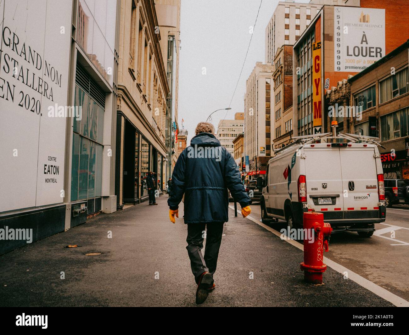 A back view of a man walking on a street Stock Photo - Alamy