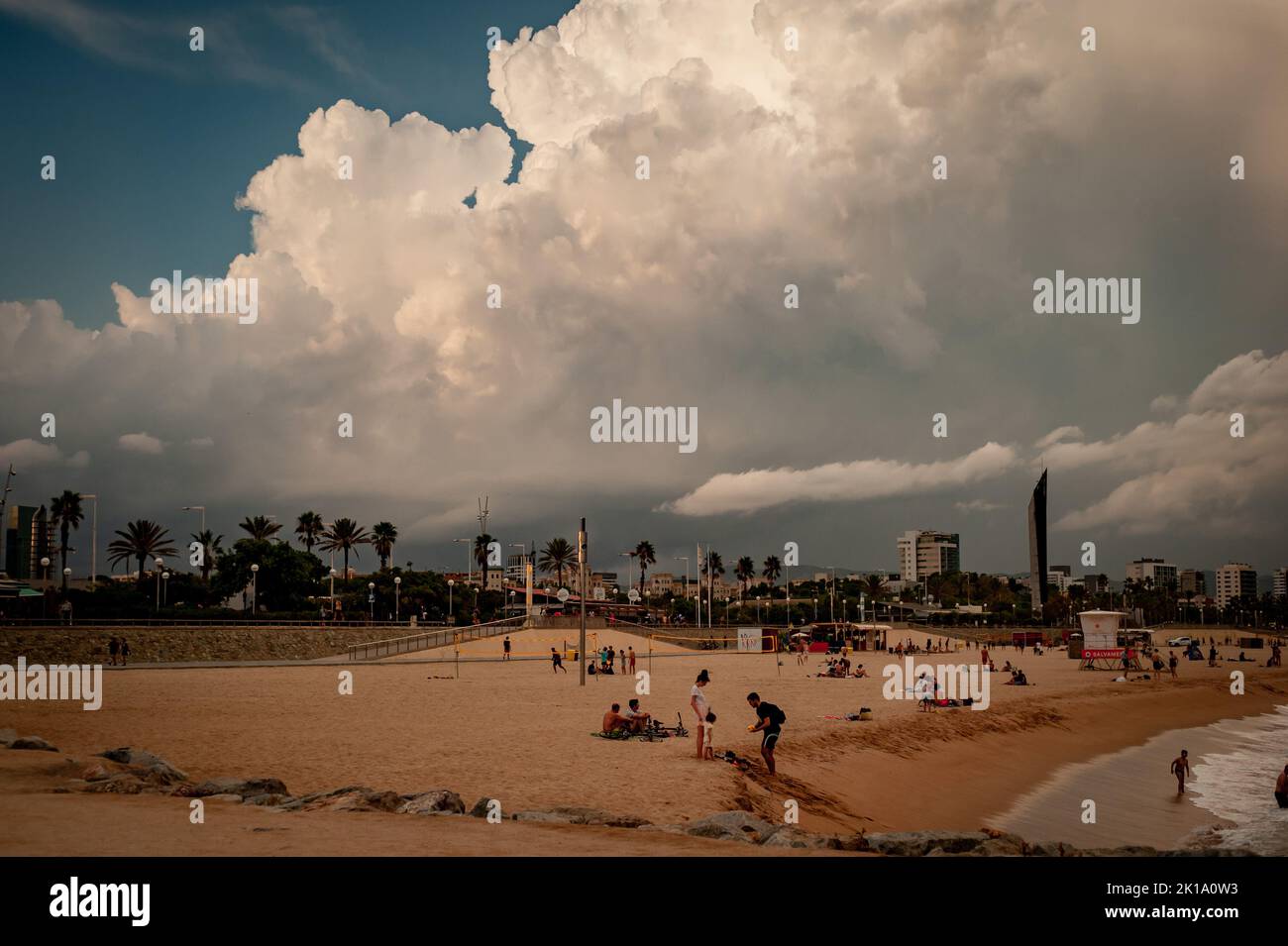 September 16, 2022, Barcelona, Spain: People spend the afternoon at the beach as stormy clouds roll across the sky in Barcelona, Spain. Credit: Jordi Boixareu/Alamy Live News Stock Photo
