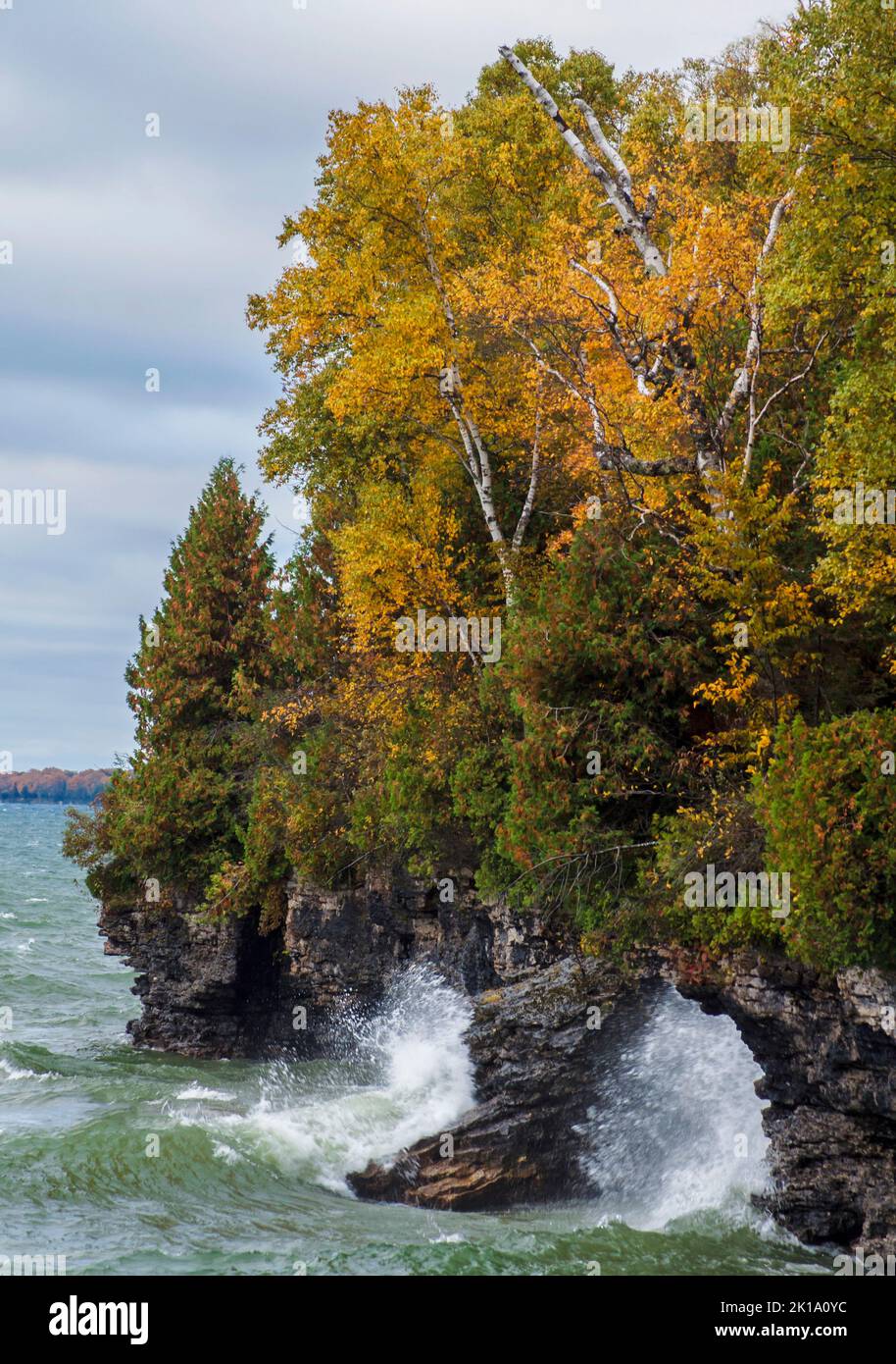 Giant waves crash the autumn Lake Michigan shore at Cave Point County