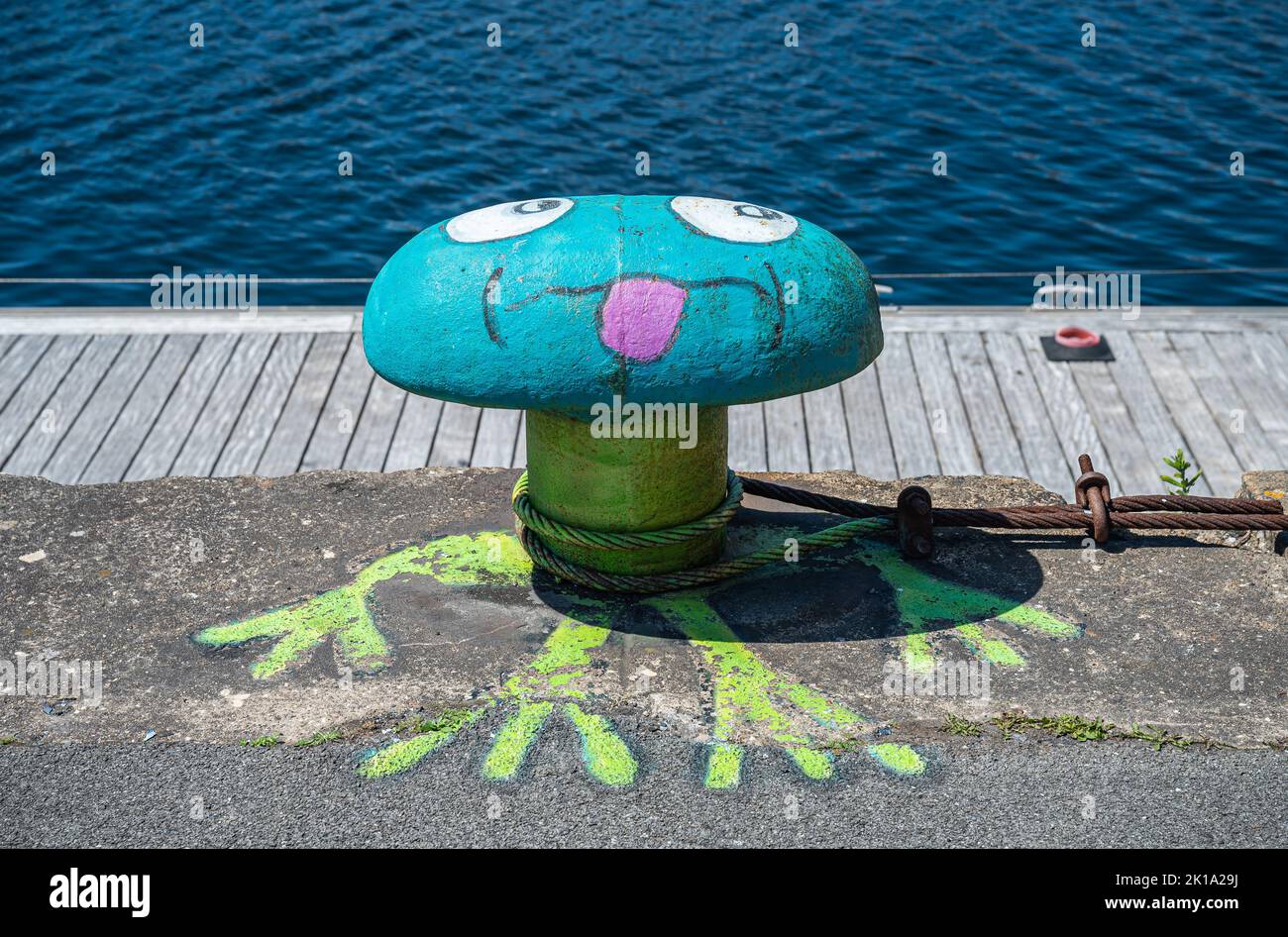 Europe, France, Dunkerque - July 9, 2022: Art closeup, bollard  on Port du Bassin de la Marine quay painted azure, green, white and pink as out of thi Stock Photo