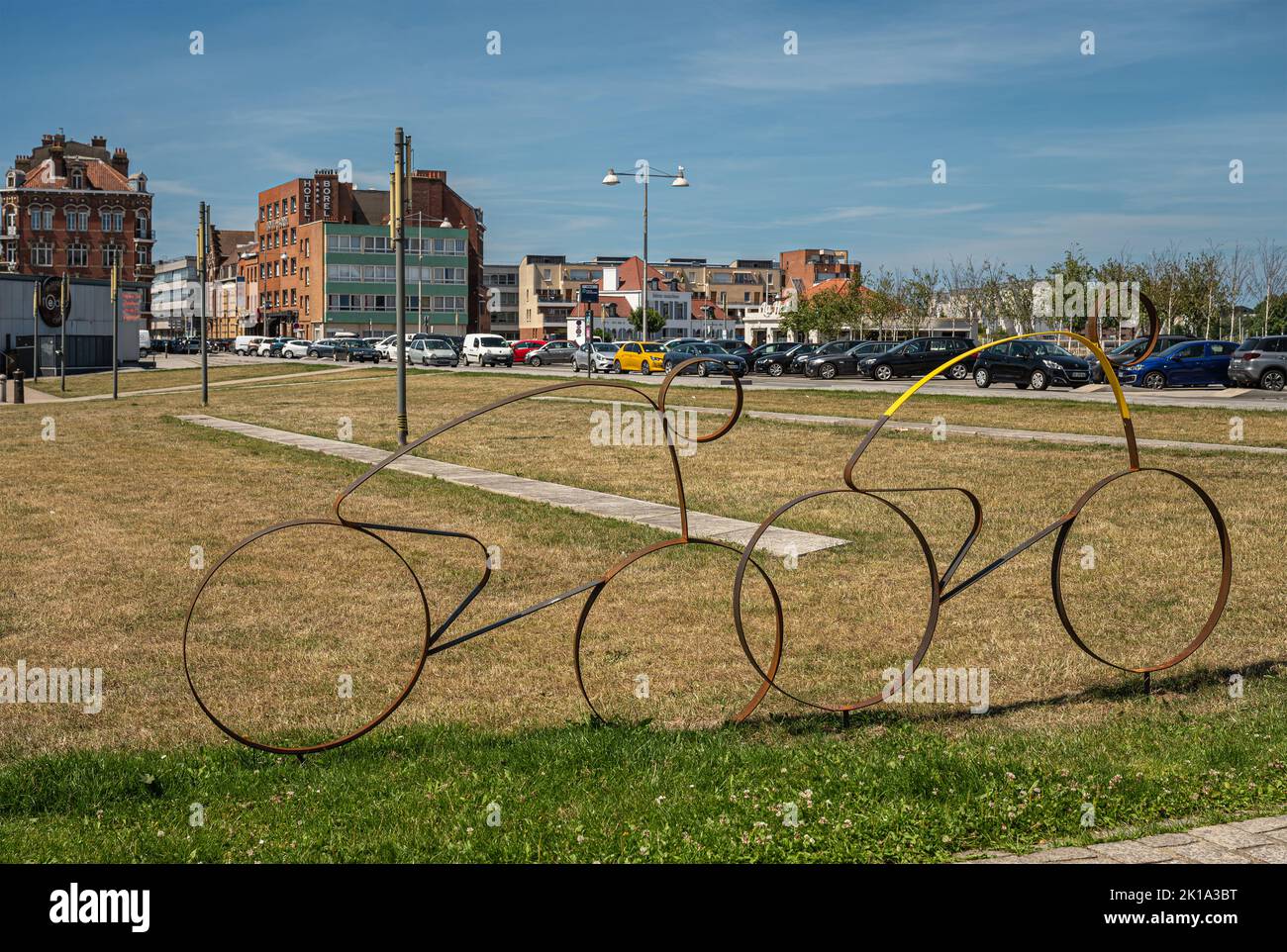 Europe, France, Dunkerque - July 9, 2022: Tour de France memorabilia. 2 rusted bicycle with rider profiles, 1 yellow shirt, on lawn of Place du Mynck Stock Photo