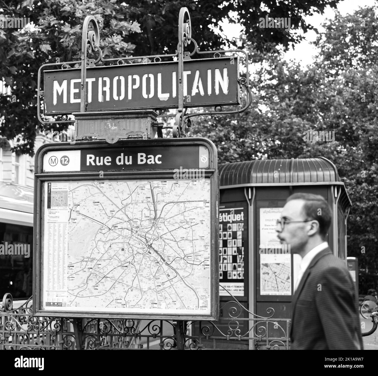 Sign with the subway logo in front of a parisian metro (metropolitain) station. Old times, vintage, nostalgia concept. Historic black and white photo. Stock Photo