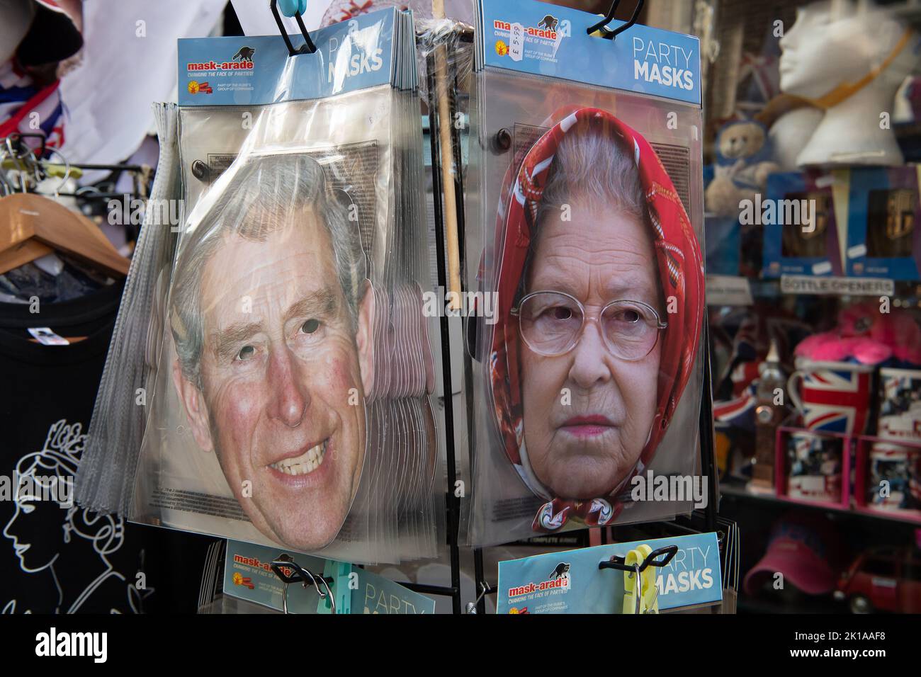 Windsor, Berkshire, UK. 16th September, 2022. Cardboard cut out face masks for sale in a tourist shop. The town of Windsor prepares for the return of Her Majesty the Queen on Monday after her State Funeral in London. Queen Elizabeth. Following a committal service at Westminster Abbey, Her Majesty will be laid to rest in the King George VI Memorial Chapel, St George's Chapel at Windsor Castle at a private ceremony attended by the Royal family. Credit: Maureen McLean/Alamy Live News Stock Photo