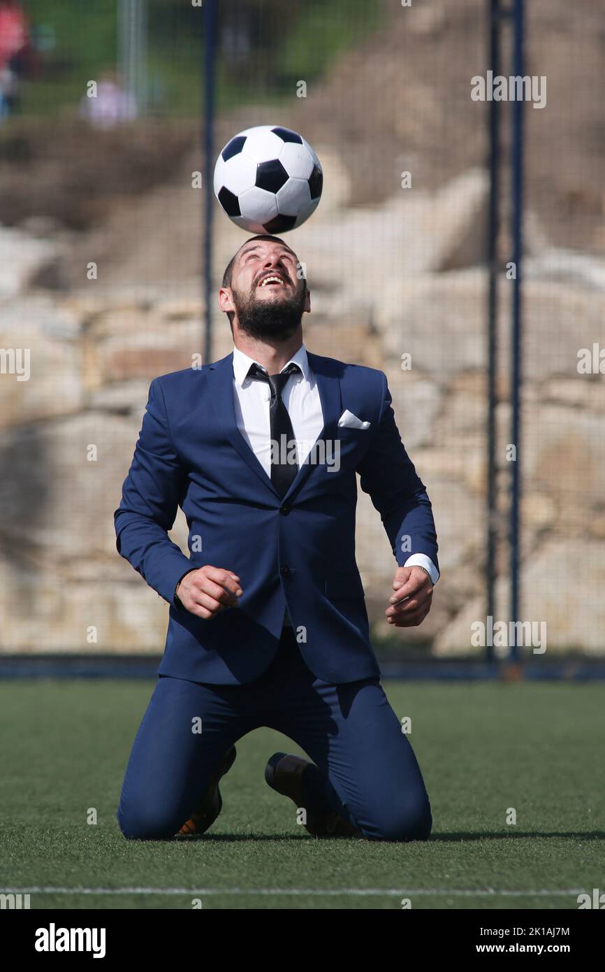 Businessman playing soccer ball Stock Photo - Alamy