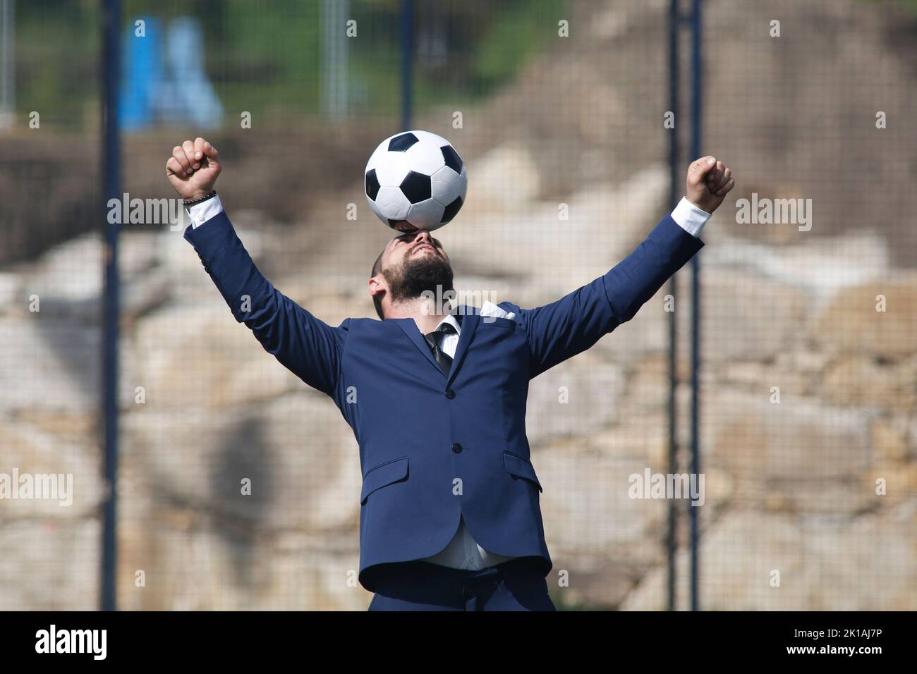 businessman with a ball on his head celebrating a goal inside a soccer ...