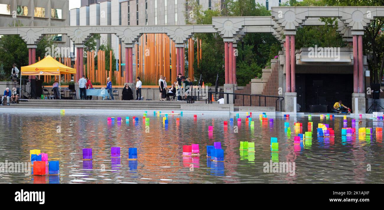 Colorful floating lanterns at the Floating Lantern Peace Ceremony in the reflecting pool at Olympic Plaza, Calgary, Canada Stock Photo