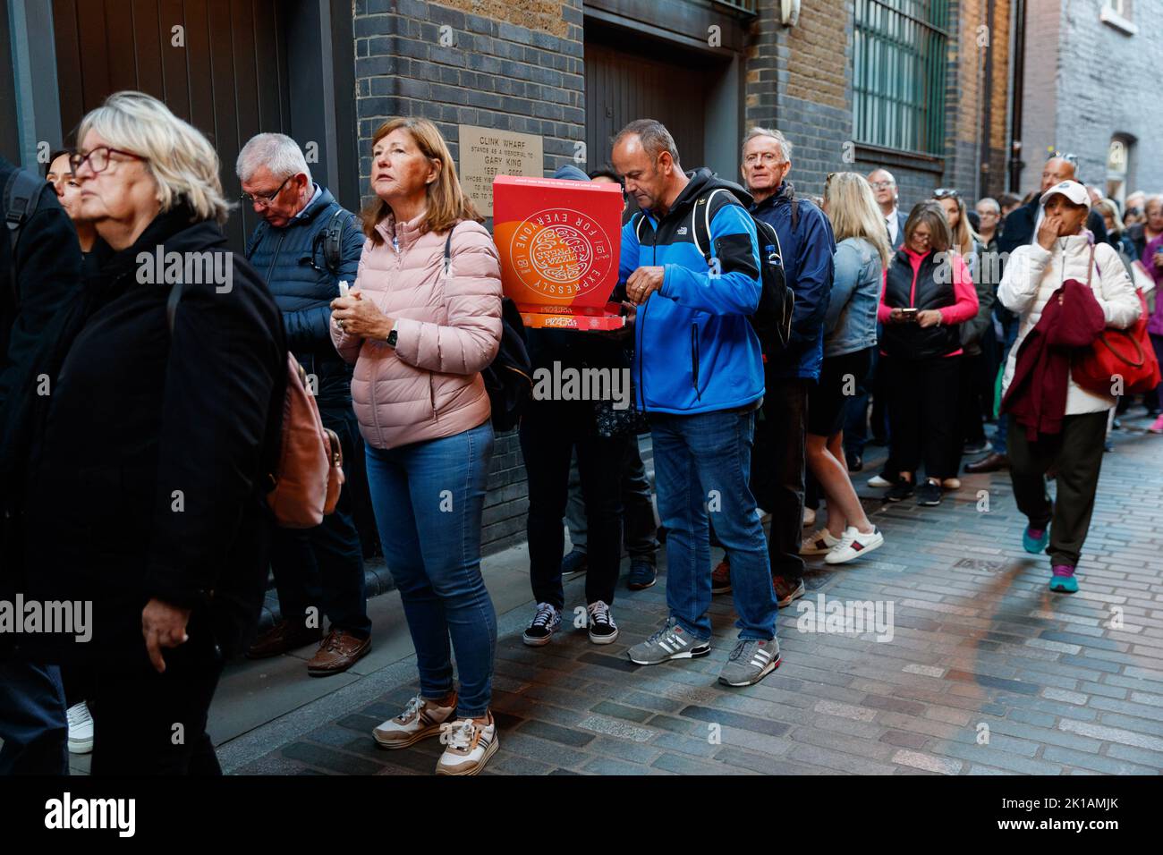 Respect The Queue London, UK. 16th Sep, 2022. People have pizza at 6:30 evening while ...