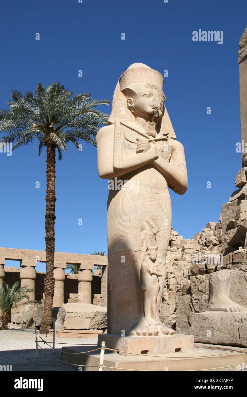 Statue of Ramesses II with folding arms in Karnak temple in Luxor ...