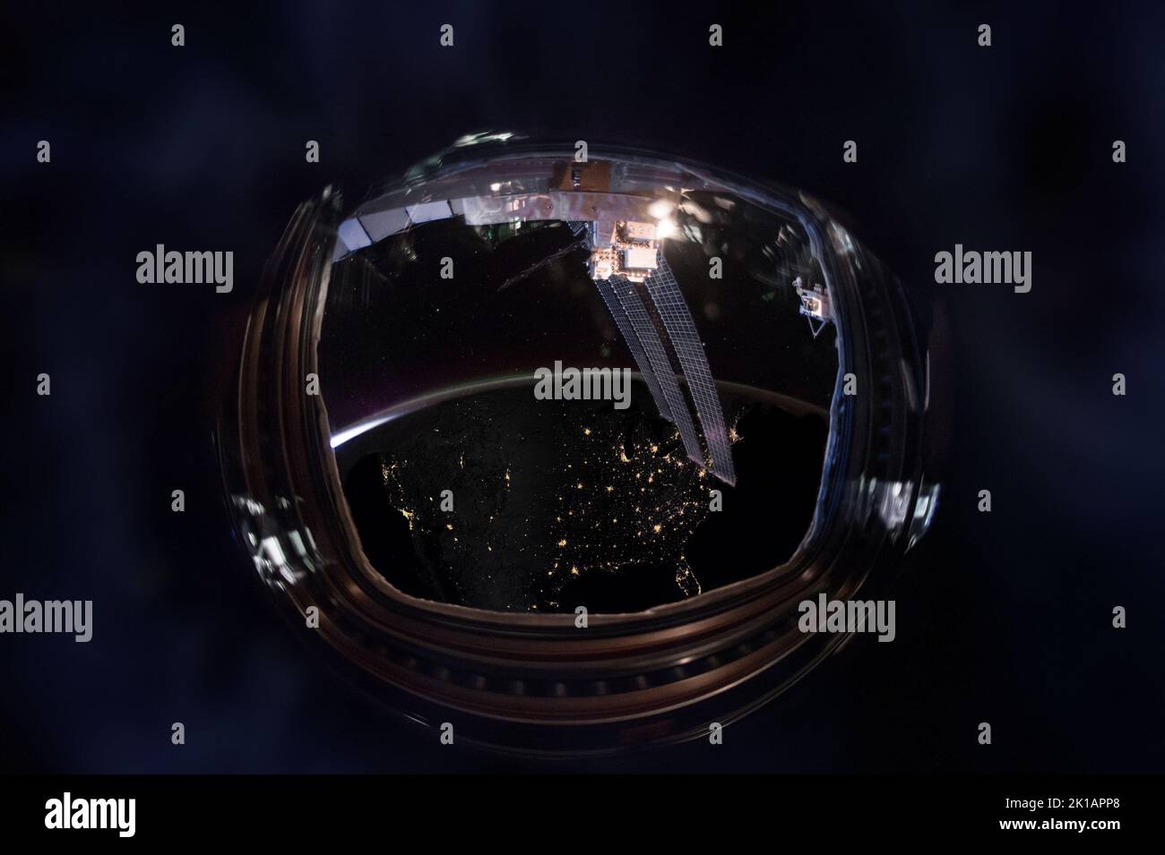 Porthole wide fisheye lens night view of the Earth with United States map of illuminated cities. Elements of this image furnished by NASA. Stock Photo