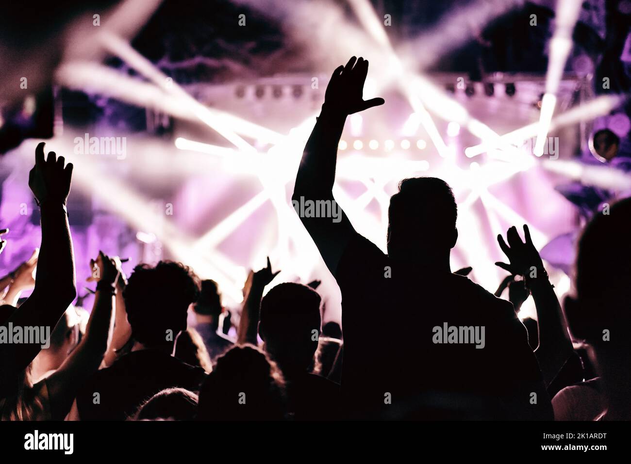 Concert crowd with raised arms applauding at a music festival Stock Photo