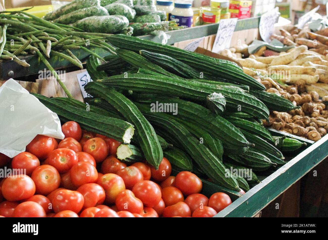 Tomatoes, snake beans, yams and silk squash (aka Chinese gourd, sin qua or luffa) for sale at Paddy’s Fresh Food Market in Flemington, Sydney Stock Photo