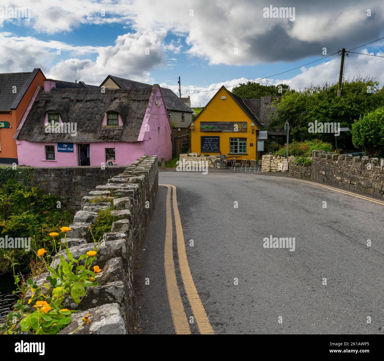Doolin, Ireland - 3 August, 2022: bridge leads to colorful houses in the old village center of Doolin Stock Photo