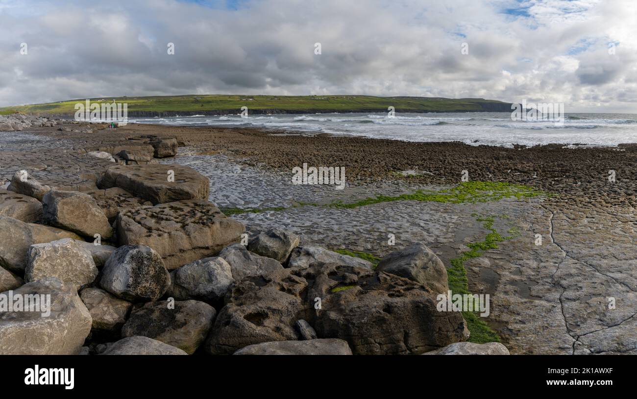 panorama view of the glaciokarst coastline at Doolin Harbor with the Cliffs of Moher in the background Stock Photo