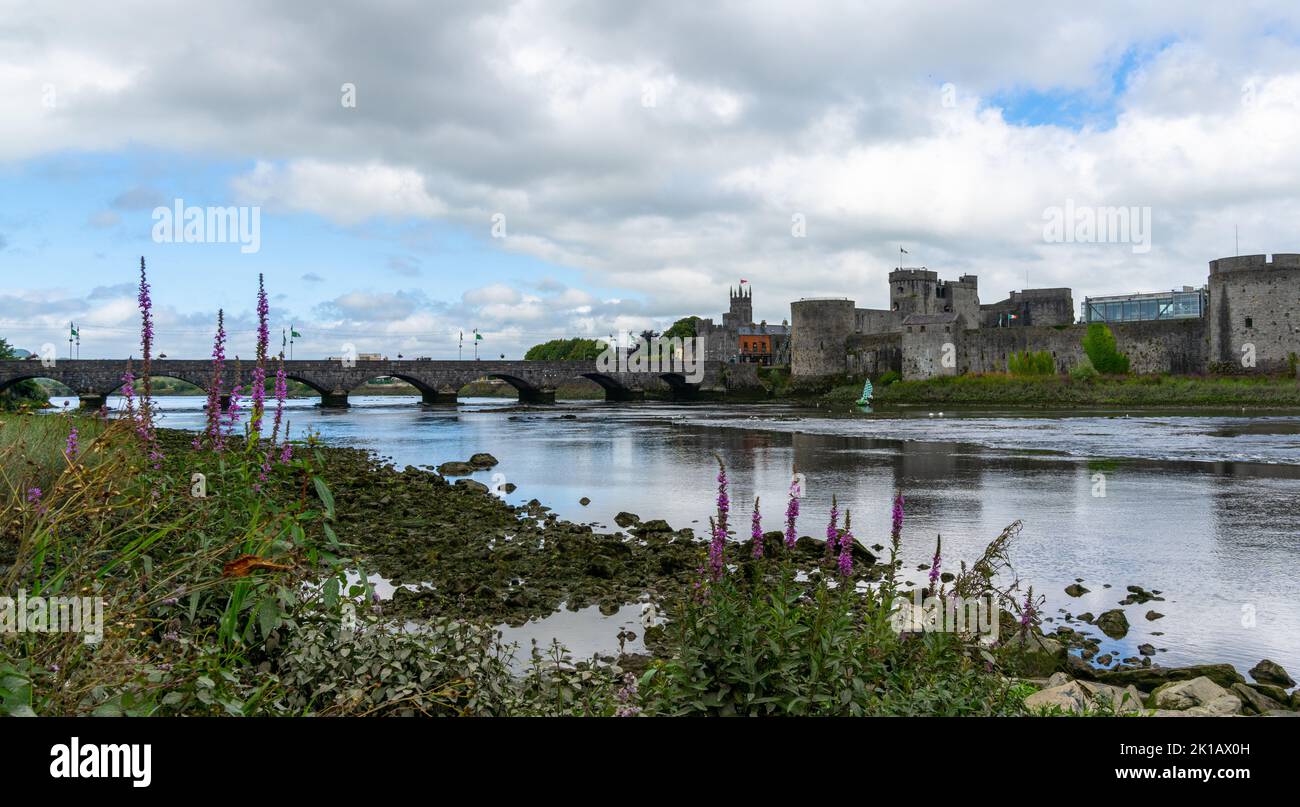 Limerick, Ireland - 2 August, 2022: panorama view of the Shannon River and Kong John's Castle in Limerick with the Thomond Bridge in the background Stock Photo