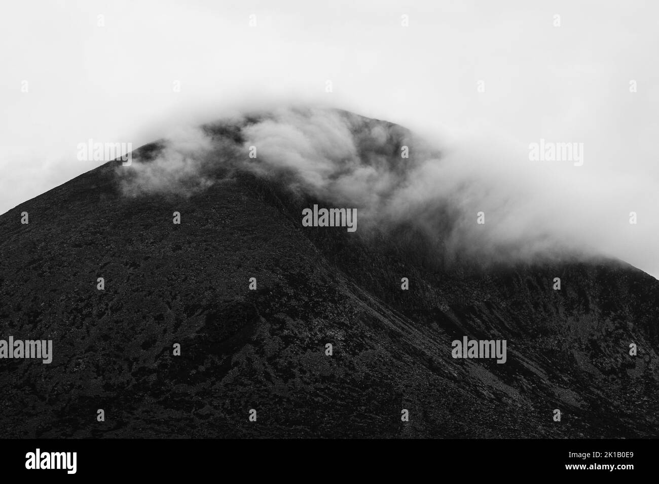 A scenery of a mountain covered with fog and clouds Stock Photo - Alamy