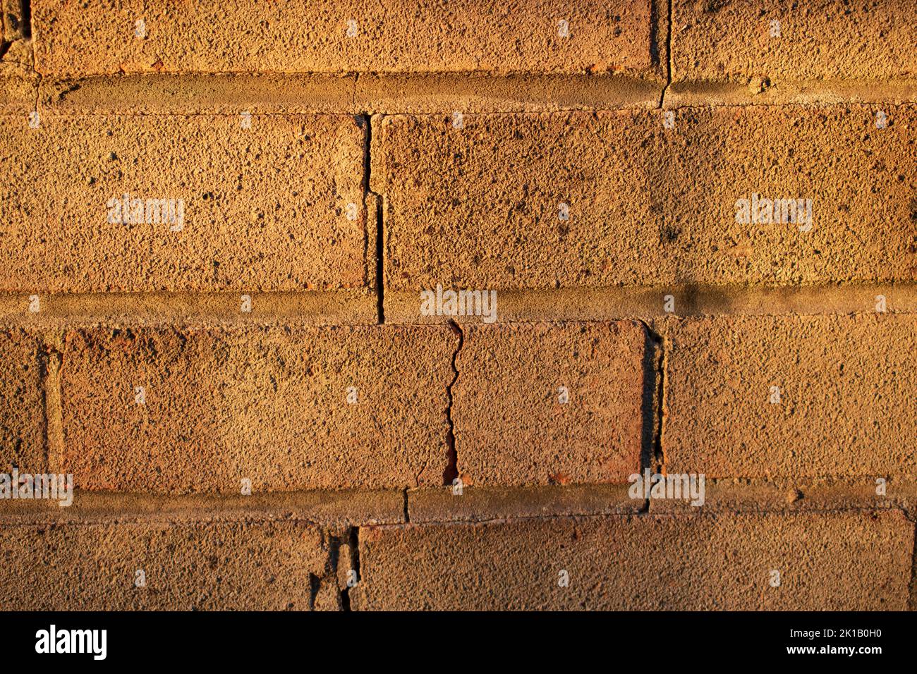 Cracked brick in a wall Stock Photo