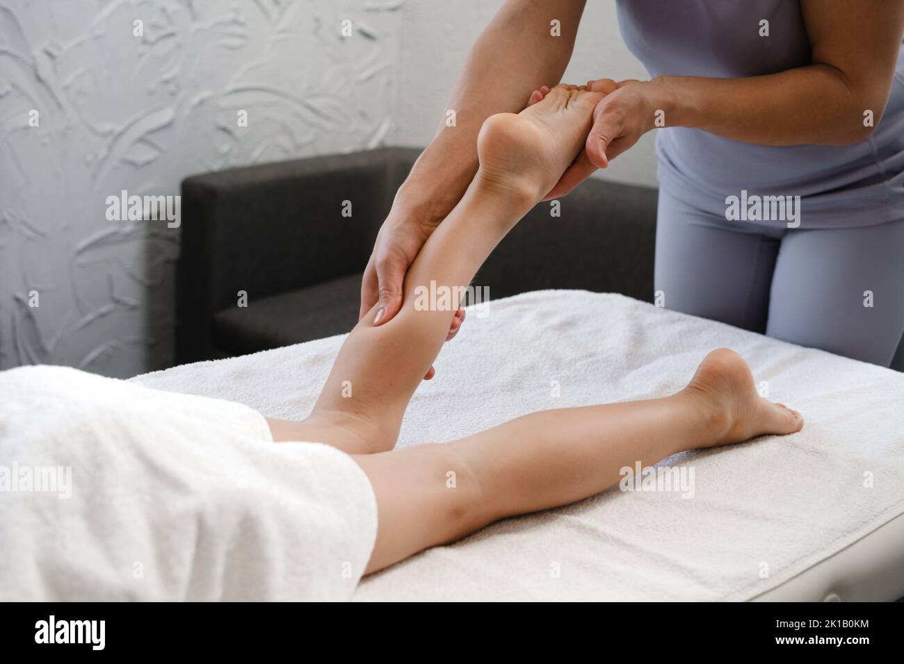 Child Foot massage treatment by professional massage therapist in spa resort. Wellness, stress relief and healthcare concept. Close-up. Growth and Stock Photo