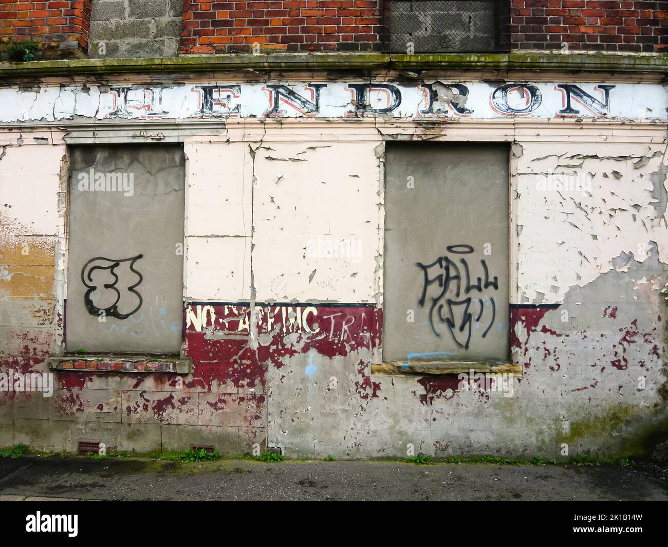 Graffiti on the walls of a derelict shop in Belfast Stock Photo