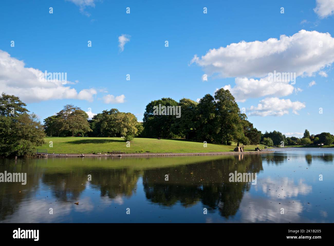 Nice view of Sefton Park lake in Liverpool using an ND64 filter to smooth the water on a sunny autumn day. Stock Photo