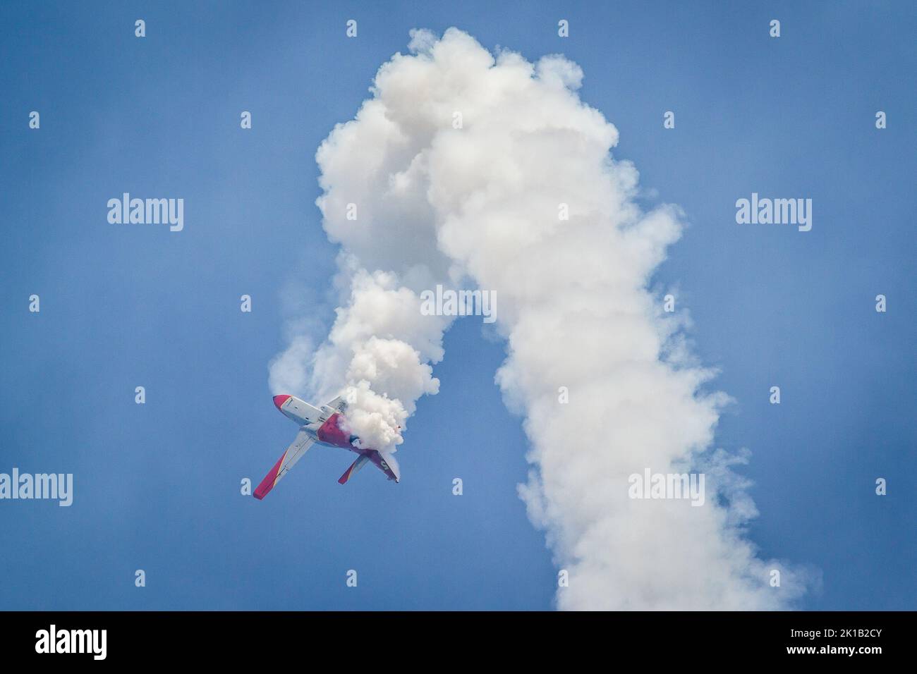 The solo pilot of aerobatic team Patrulla Águila  performing a corkscrew manouveur at an airshow Stock Photo