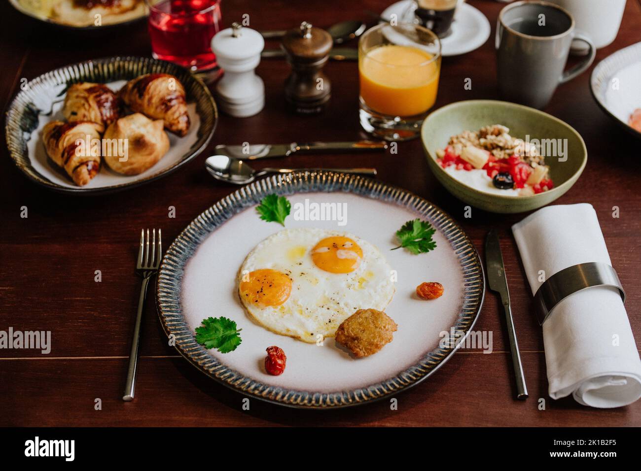 A top view of scrambled eggs in a plate on a wooden table for breakfast ...