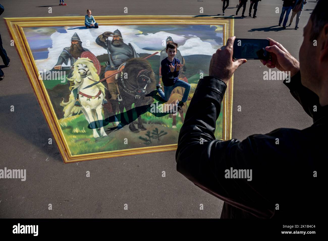 Moscow, Russia. 12th of September, 2022. Children ride on a 3D replica of 'Bogatyrs' painting by Viktor Vasnetsov. at the Exhibition of Achievements of National Economy (VDNH) in Moscow, Russia Stock Photo