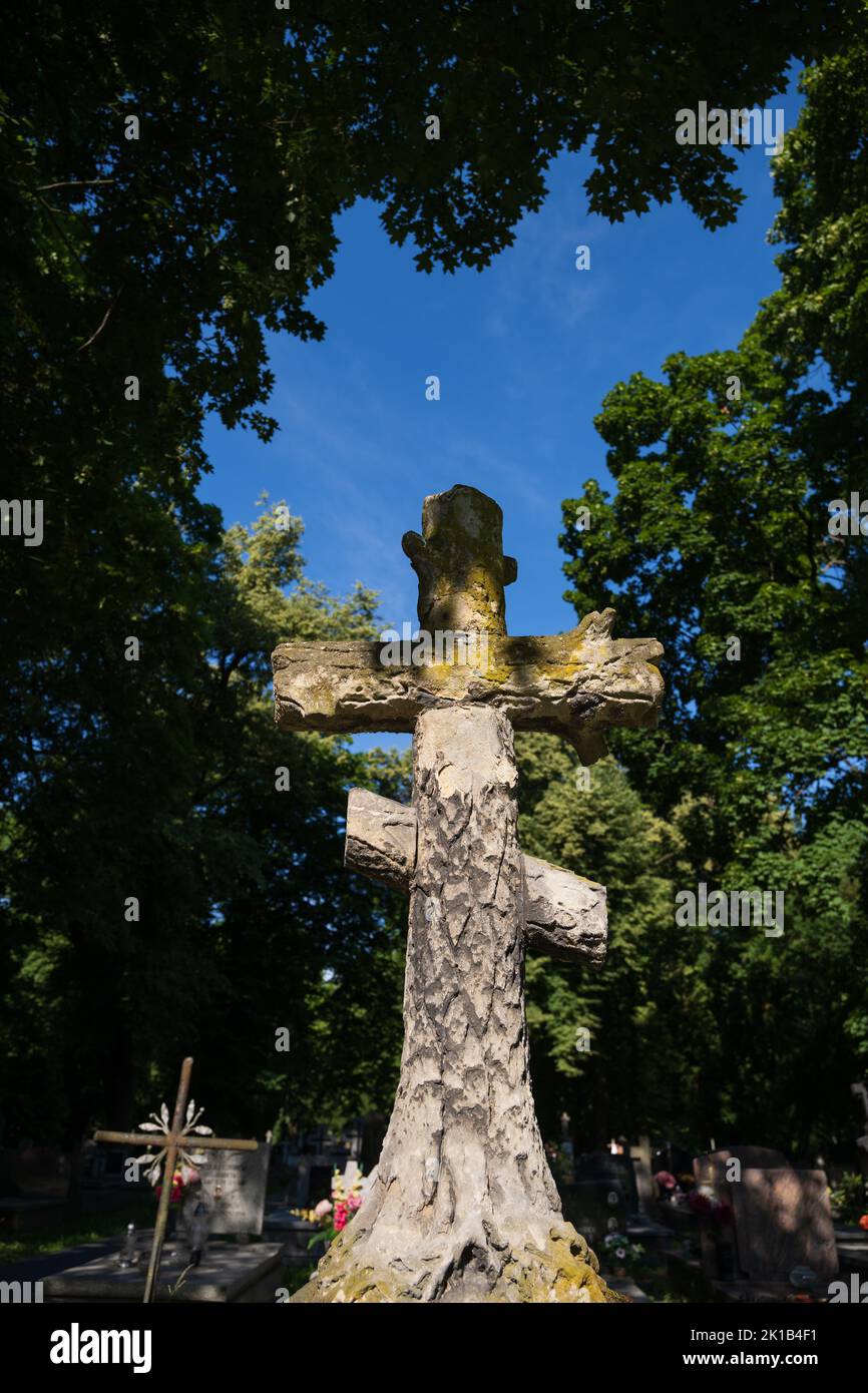 Old stone Orthodox cross in 19th century historic Eastern Orthodox cemetery in the Wola district of Warsaw, Poland. Stock Photo