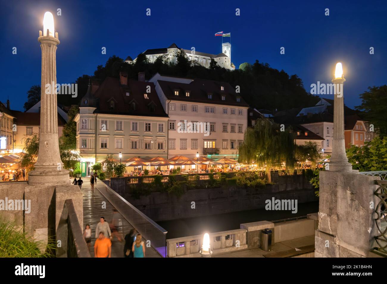 City of Ljubljana at night in Slovenia, view to Castle Hill and Fishmarket Footbridge on Ljubljanica River. Stock Photo