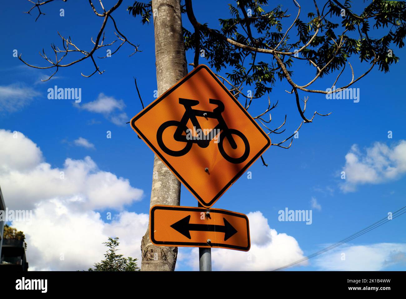Orange bikeway sign against blue sky in Brisbane Australia Stock Photo
