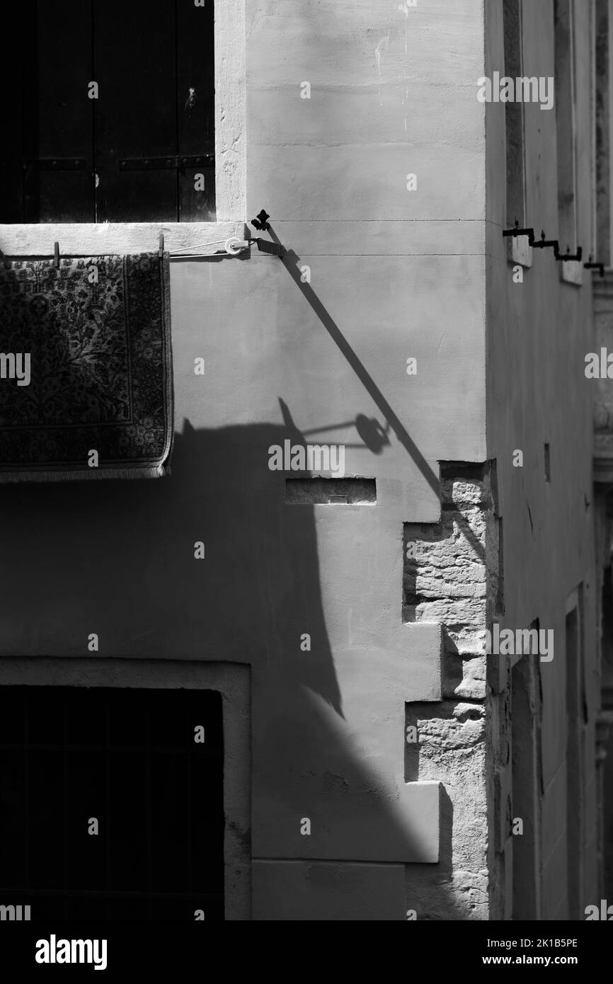 A vertical grayscale shot of the facade of an apartment building Stock ...