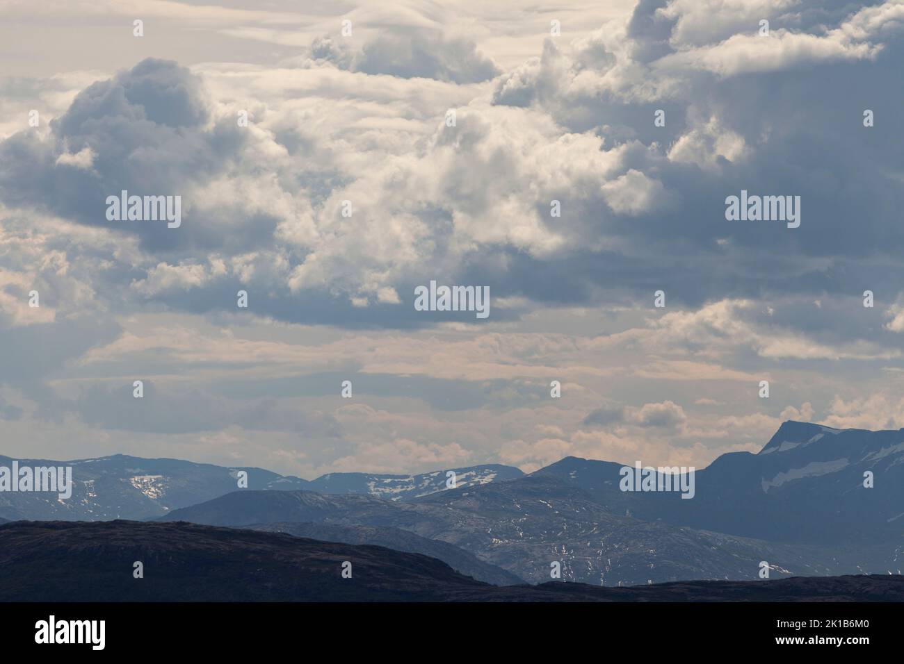 Nordic landscape, mountains and valleys with a cloudy sky above. Stock Photo