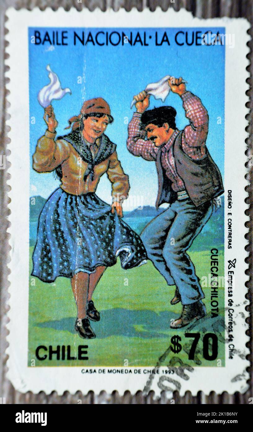 Cairo, Egypt, August 15 2022: Old used postage stamp printed in Chile features the national Chilean dance of The Cueca, selective focus of old Chilean Stock Photo