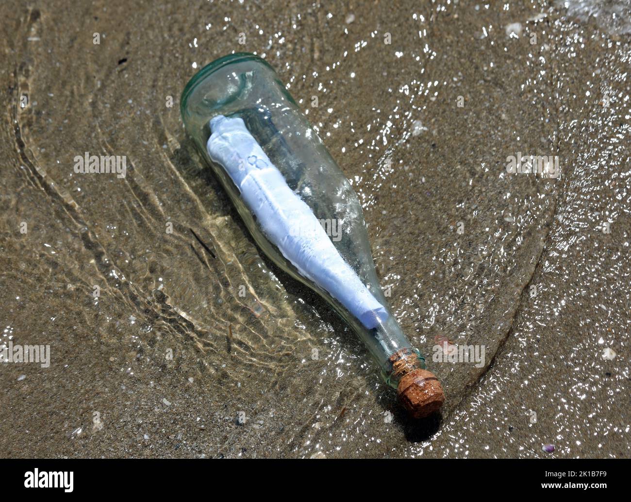 transparent glass bottle with secret message closed with a cork by the ...