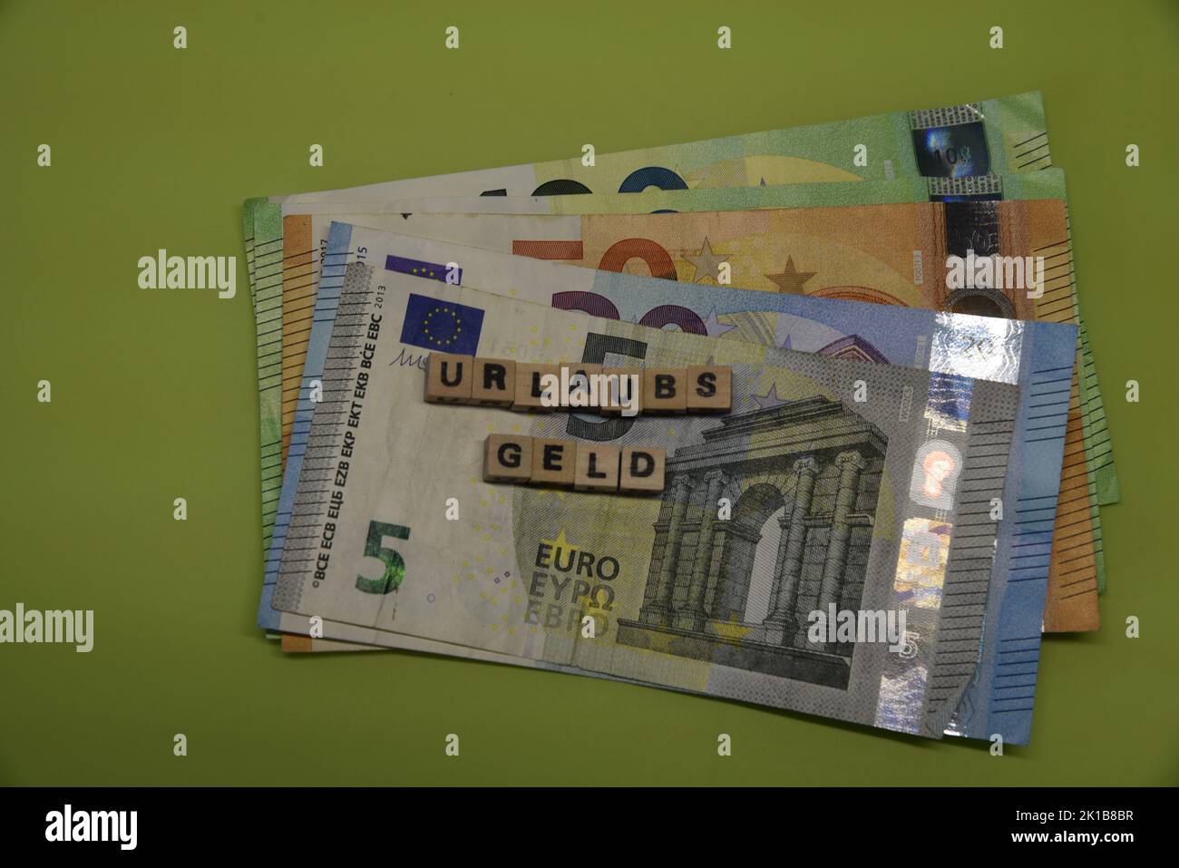 the german word for a vacatiob payment with wodden bricks and euro bank notes Stock Photo