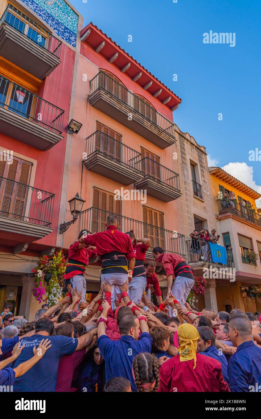 CAMBRILS, SPAIN - SEPTEMBER 04.2022: Castells Performance, a castell is a human tower built traditionally in festivals within Tarragona, vertical Stock Photo