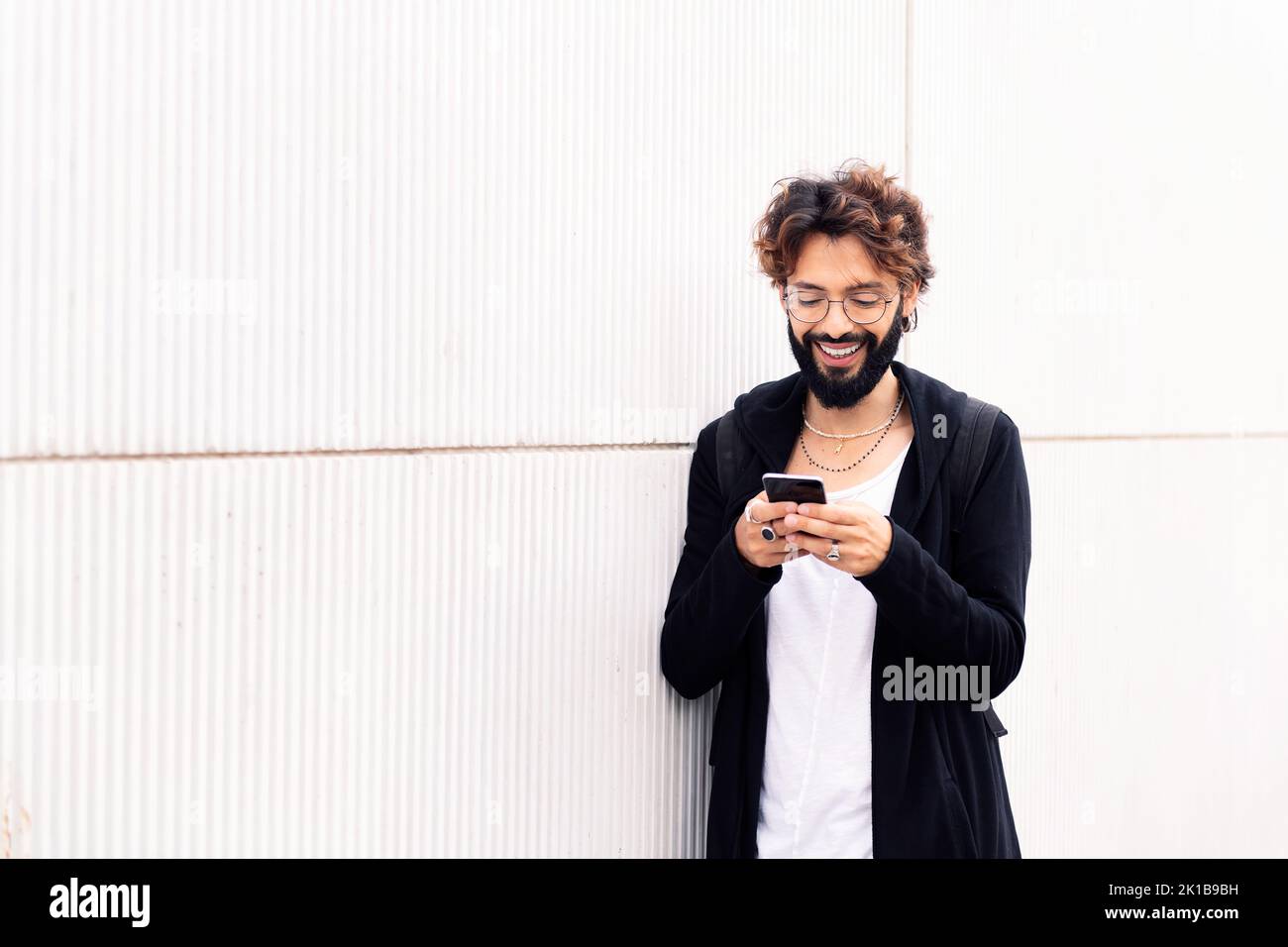 smiling young man talking on mobile phone Stock Photo