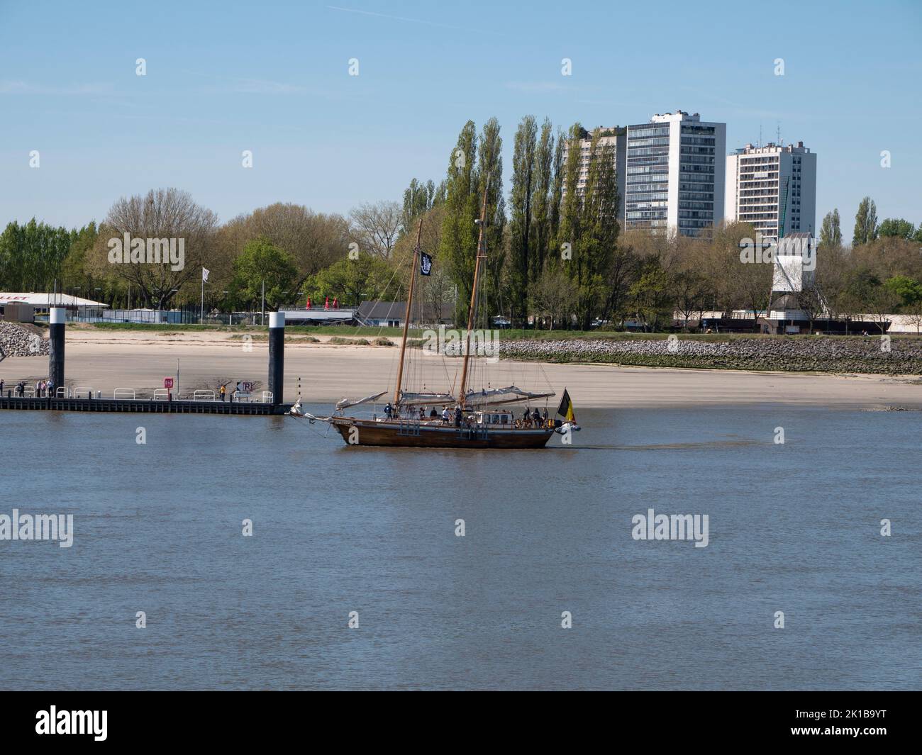 Antwerp, Belgium, April 17, 2022, Old sailboat sails past Antwerp left bank Stock Photo