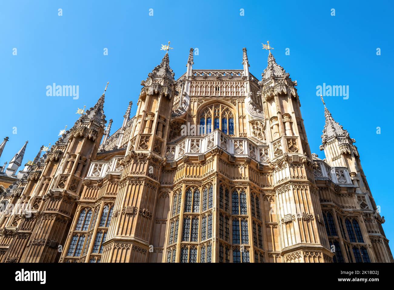Westminster Abbey, London, famous as the site of many Royal weddings, coronations and burials. Detail of this medieval building against blue sky backg Stock Photo