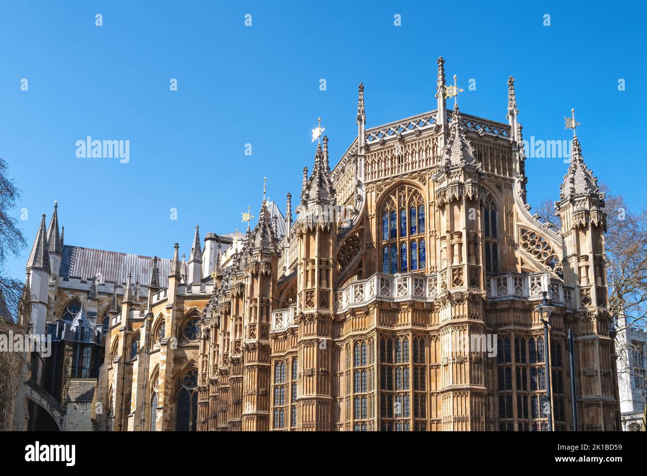 Westminster Abbey, London, famous as the site of many Royal weddings, coronations and burials. Detail of this medieval building against blue sky backg Stock Photo