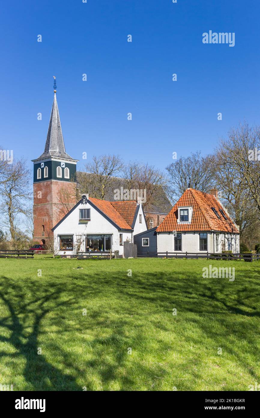 Historic church and white houses in Frisian village Makkum, Holland Stock Photo