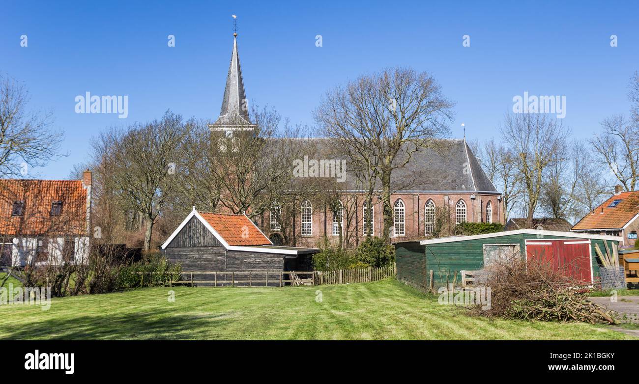 Historic church and sheds in Frisian village Makkum, Netherlands Stock Photo