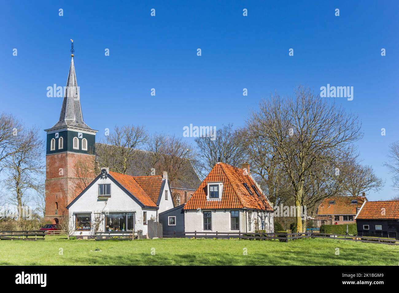 Historic church and white houses in Makkum, Holland Stock Photo