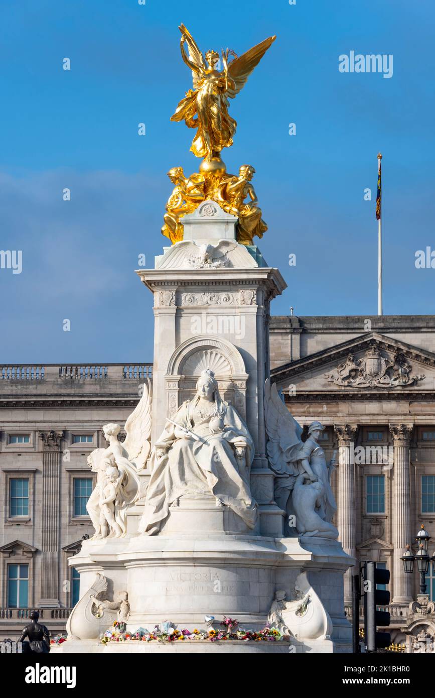 Flowers laid around bronze statue of Victoria Memorial outside