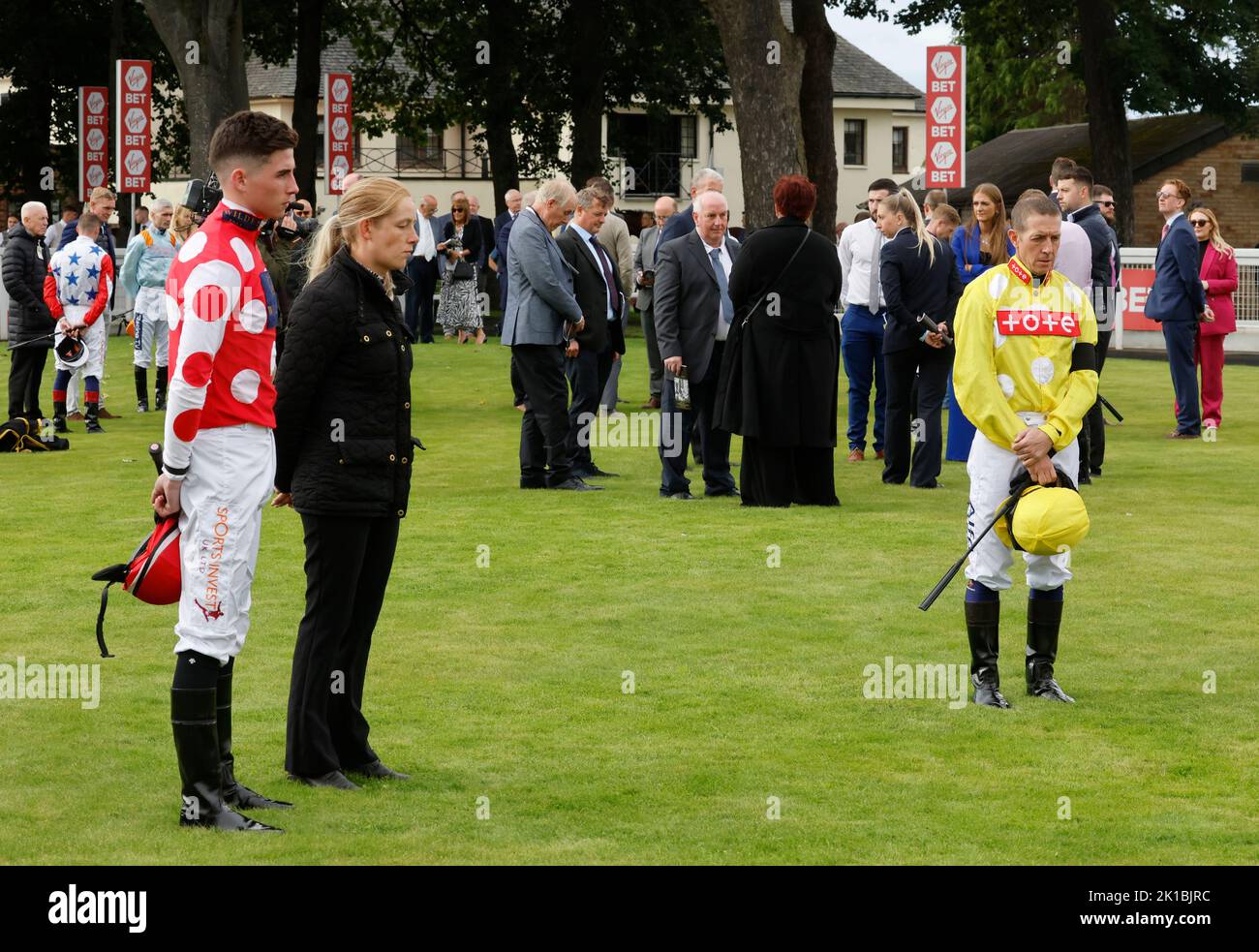 Jockeys and connections observe a minute's silence in memory of Queen Elizabeth II, ahead of the Virgin Bet Ayr Gold Cup day at Ayr Racecourse, Ayr. Picture date: Saturday September 17, 2022. Stock Photo