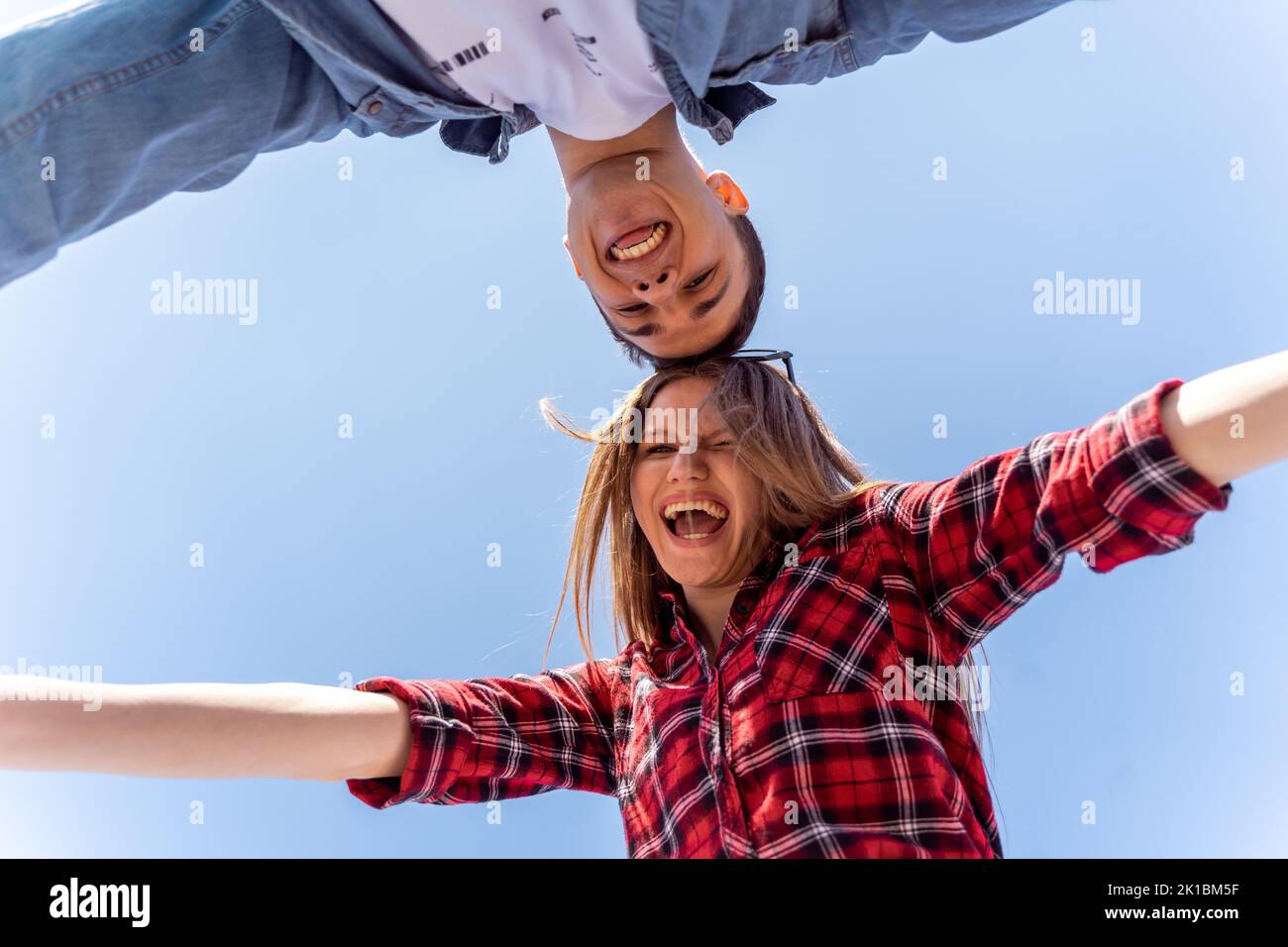 Cute couple posing while smiling from below Stock Photo