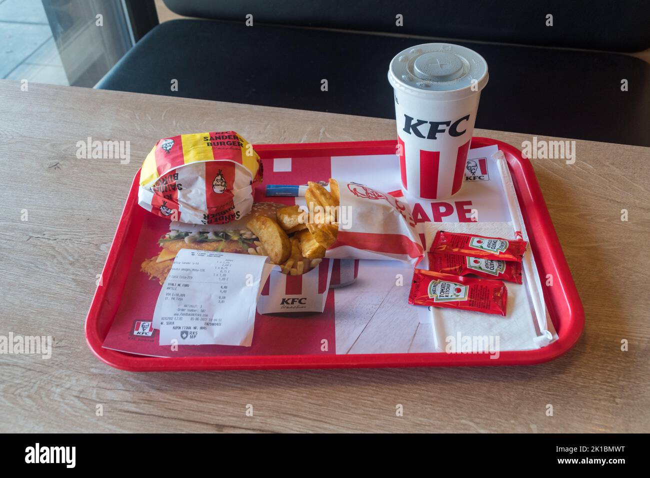 Pristina, Kosovo - June 5, 2022: KFC menu with spicy Sander Burger, Potato Wedges and Pepsi for drink. Stock Photo