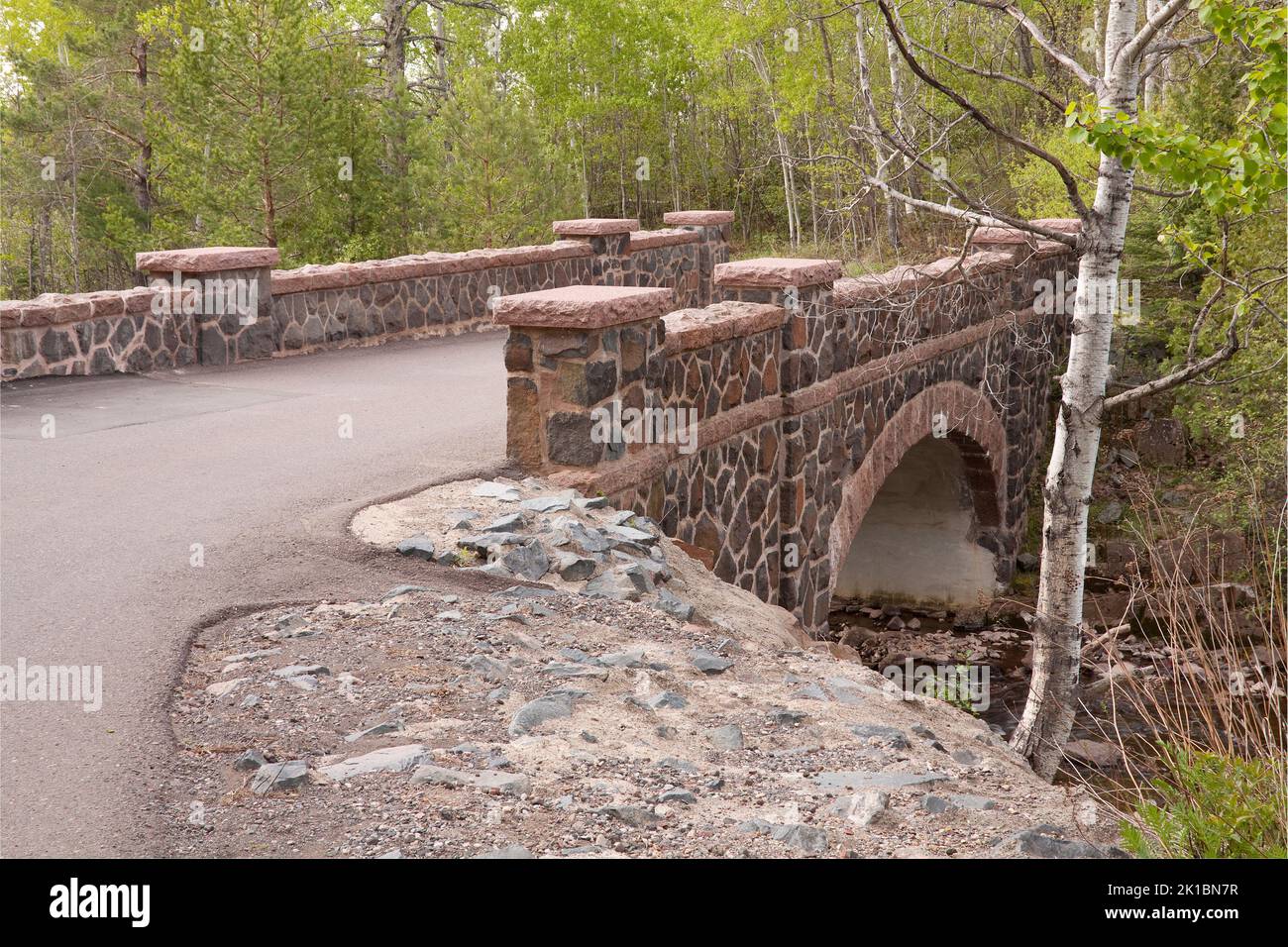A Stone Arch Bridge Crossing A Creek In The Woods Stock Photo - Alamy