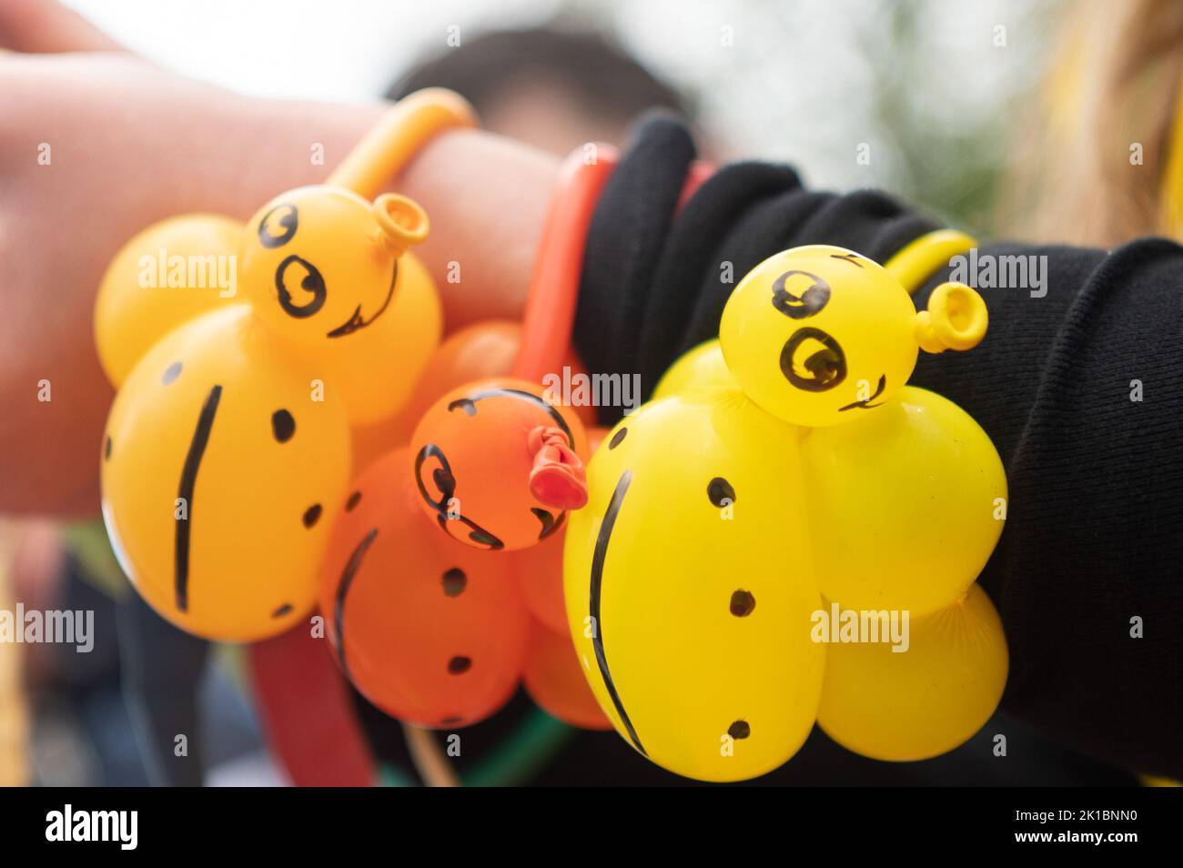 Langenselbold, Germany. 17th Sep, 2022. Three ladybugs made of balloons hang from a woman's wrist during the triplet meeting at Langenselbold Castle. For more than two decades, the Minister President of Hesse has been the honorary sponsor of multiple births starting with triplets in Hesse. Credit: Sebastian Gollnow/dpa/Alamy Live News Stock Photo