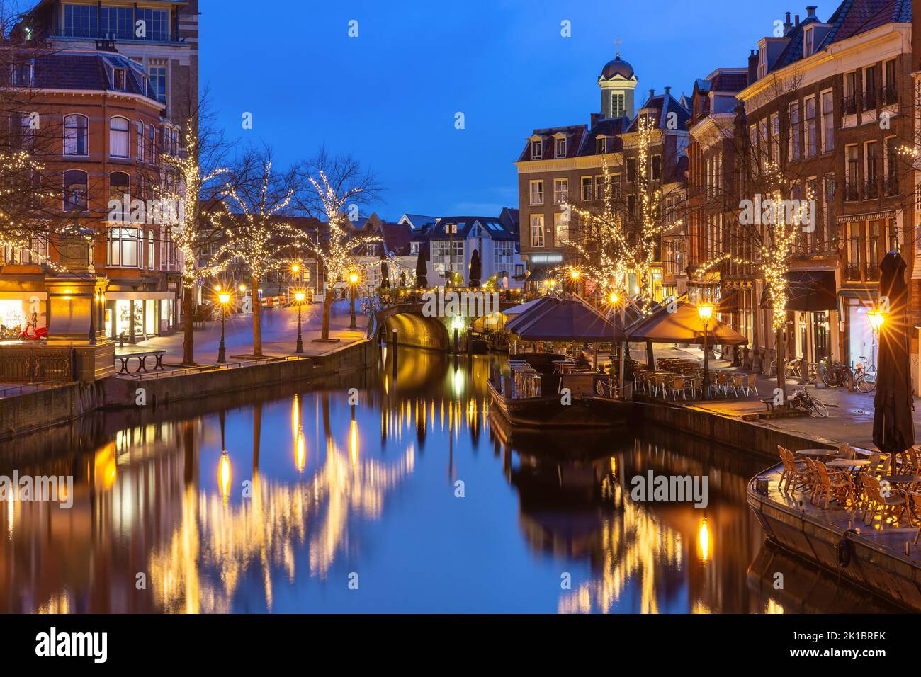 Night Leiden canal Oude Rijn in Christmas illumination, South Holland, Netherlands. Stock Photo